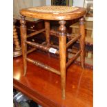 A Victorian stained beech stool with remains of rattan seat panel, set on turned supports