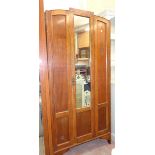 A 35" 1930`s polished oak and mixed wood wardrobe with hanging space enclosed by a mirror panel door