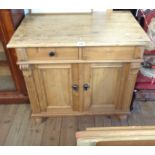 A 33" 20th Century pine cabinet with two frieze drawers, flanking capitals and pair of panelled