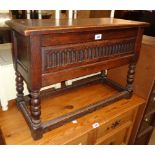 A 28 1/2" antique style oak lift-top locker chest, set on an open stretcher base with bobbin