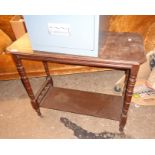 A 33" Edwardian stained mixed wood two tier table, set on turned supports and brown porcelain