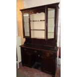 A 4' 6" Victorian stained pine two part dresser with three central scalloped shelves and flanking