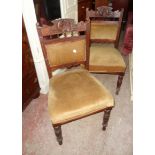 A set of four Edwardian walnut framed dining chairs with shell and acanthus back rails,