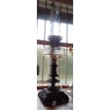 A Victorian table oil lamp with ornate cast iron base