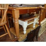 A 4' 6" modern Regent Pine polished kitchen table with fitted cutlery drawer, set on turned legs