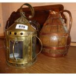 A brass candle lantern and copper bound jug