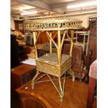 A vintage cane work and woven plastic occasional table with locker undertier - later painted gilt
