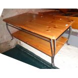 A 3' 7 1/2" modern painted wrought iron framed coffee table with polished pine top and undertier