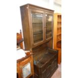 A 3' 3" Ercol dark stained elm two part dresser with bevelled glazed panel doors to top over a