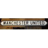 A modern painted wood Manchester United street sign