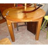 A 3' 7 1/2" diameter 20th Century oak and mixed wood extending dining table with stowed folding leaf