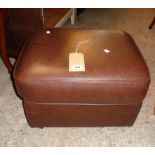 A pair of modern brown leather upholstered pouffes, set on castors