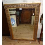 A modern gilt framed bevelled oblong wall mirror with decorative textured border - 3' X 26"