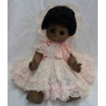 A modern black doll with sleeping eyes