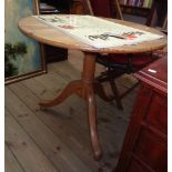 A 32 1/2" diameter waxed pine birdcage pedestal table, set on turned pillar and tripod base with