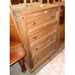 A 36 1/4" Mexican pine chest of four long graduated drawers with iron studs and plinth base - two