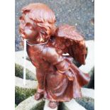 A cast iron garden angel with rusted finish
