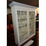 A 3' 3 1/2" later painted antique book cabinet with shelves enclosed by a pair of astragal glazed