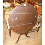 A 28 1/2" diameter 19th Century stained oak pedestal table, set on turned pillar and tripod base