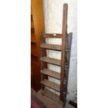 An antique stained wood six tread library steps with balustrade hand rail to one side