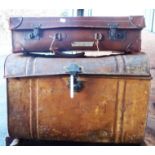 A tin trunk and vintage suitcase