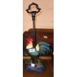 A modern cast iron cockerel pattern door stop