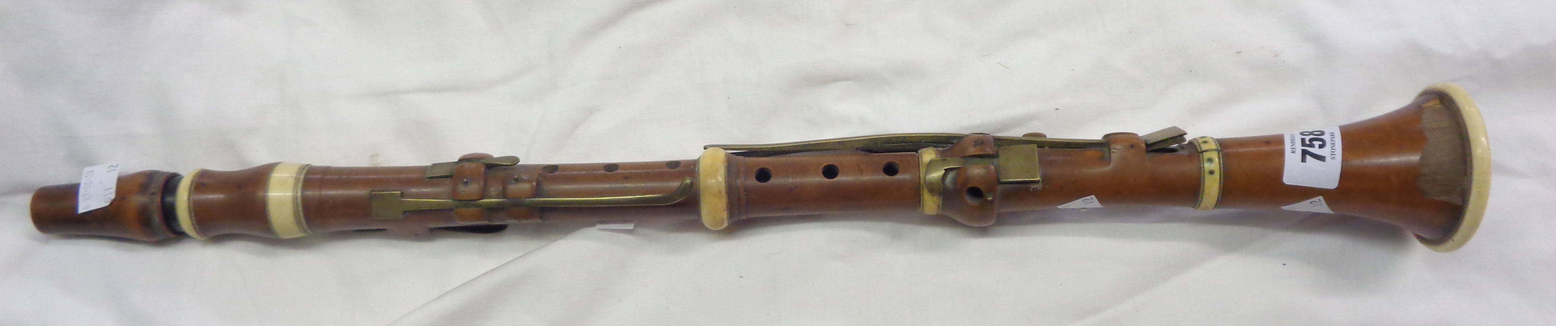 An early 19th Century boxwood and ivory bound clarinet with brass keys by Hermann Wrede of