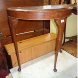 A 30" 20th Century stained mixed wood chinoiserie style demi-lune side table, set on slender legs