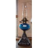 A Victorian table oil lamp with ribbed blue glass reservoir and cast iron base