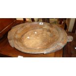 A 17" antique ethnic treen shallow dish with simple rope twist border and one of two flanking