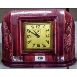 An Art Deco china mantel timepiece with streaked grape coloured glaze and decorated canted corners -