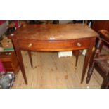 A 33" 19th Century mahogany bow front side table with frieze drawer, set on slender square tapered