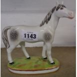 A continental porcelain figure of a Derby style standing horse - gold anchor marked