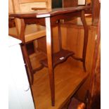 A 23 1/2" Edwardian walnut two tier occasional table with serpentine surfaces, set on slender