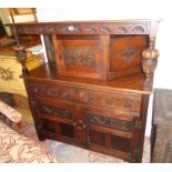 A 4' 20th Century polished oak court cupboard with carved decoration and flanking bulbous supports