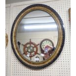 A parcel gilt framed oval wall mirror