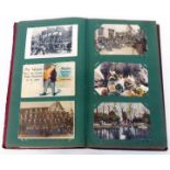 A red Edwardian postcard album containing part collection of early 20th Century and later
