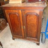 A 3' 3 1/2" Georgian quarter sawn oak cabinet with moulded top, adjustable shelves and four short