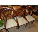 A set of six Victorian mahogany framed balloon back dining chairs with upholstered drop-in seats,