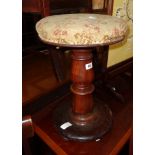 A Victorian mahogany adjustable piano stool with upholstered circular seat and metal screw action,