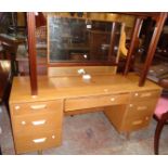 A 4' 6" vintage Stag polished light oak kneehole dressing table with oblong mirror, blind frieze