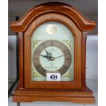 A modern Acctim polished wood cased mantel timepiece with Westminster chiming battery movement