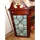 A 25" 19th Century wall hanging corner cabinet with decorative pediment, astragal glazed panel