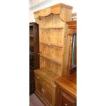 A 33" waxed pine alcove dresser with stencilled decoration to top and three open shelves over two