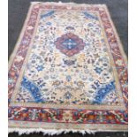 A 20th Century Chinese washed wool rug with central medallion on cream ground, within a trailing