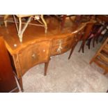 A 5' 11" Stuart Furniture reproduction mahogany, cross banded and strung serpentine front