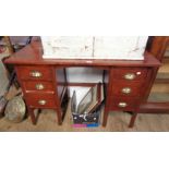 A 3' 9" vintage stained wood kneehole desk with six flanking graduated drawers, set on moulded