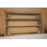 A 4' 1" painted wood three shelf open bookcase with moulded top