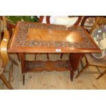 A 30" late Victorian polished oak occasional table with decorative floral scroll carved decoration