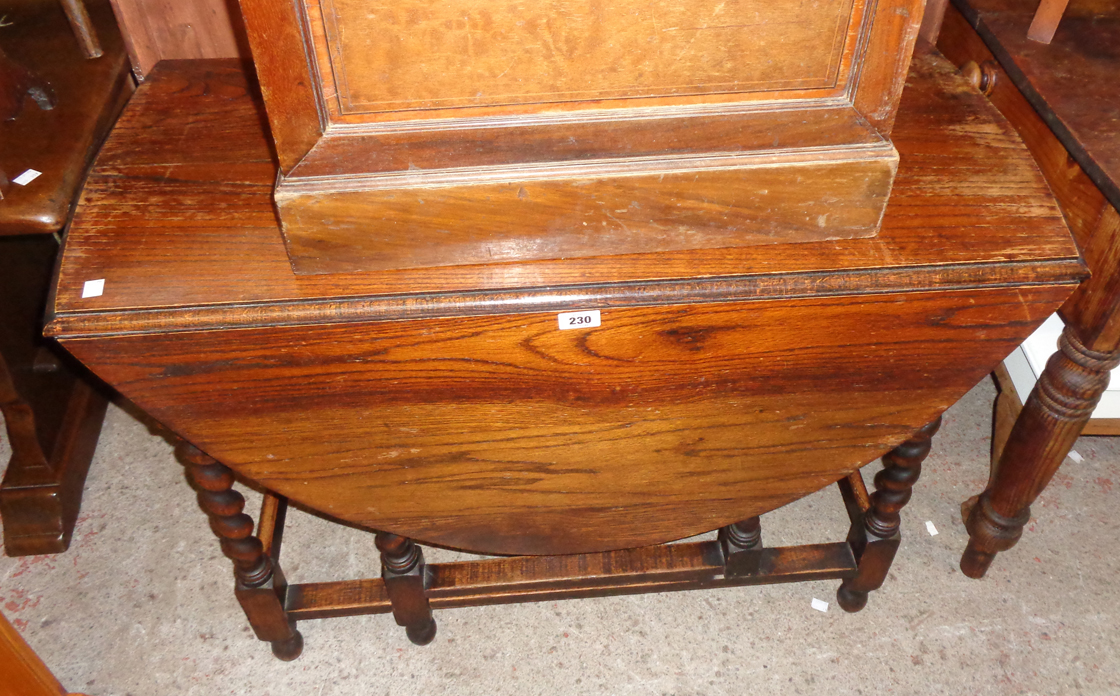 A 3' 4" 1920`s polished oak gateleg dining table, set on barley twist supports